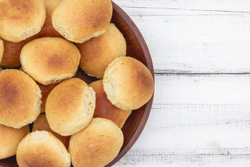 Homemade breads or bun In a clay plate on wood background. Homemade baking