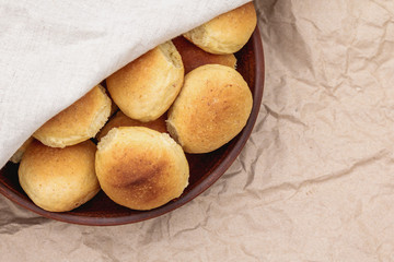 Homemade breads or bun In a clay plate on wood background. Homemade baking