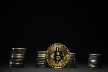 Golden bitcoin with money coins background. Bitcoin on black background