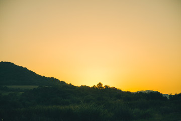 Old highway against mountains and a cloudy sky