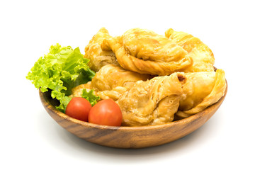 Curry Puffs, Tomatoes and Lettuce in a wooden bowl