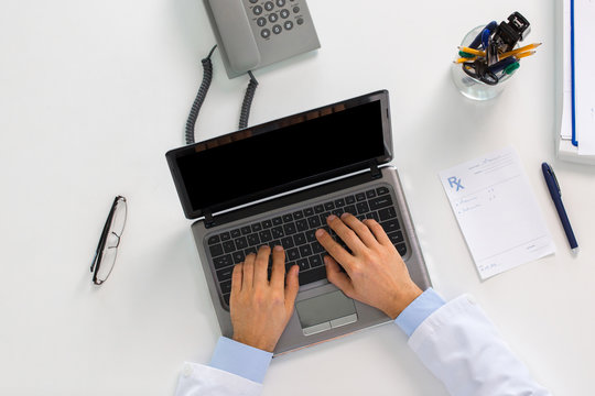 doctor hands typing on laptop at clinic