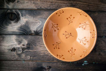 Fototapeta na wymiar Empty bowl on a wooden background