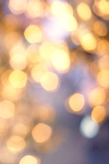 Obraz premium Christmas background with natural bokeh and twinkled defocused lights. Festive blur background .