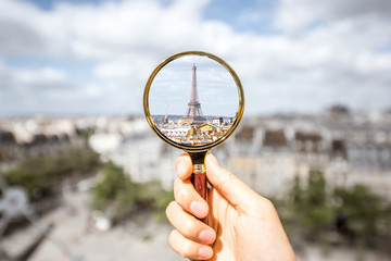 Looking on the Eiffel tower through the magnifying glass in Paris
