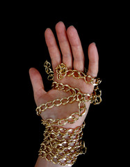 golden chain in hand, black background