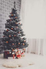 Christmas decorated tree in modern interior, holiday concept