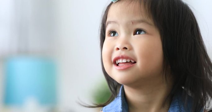 Close up portrait of beautiful young asian girl smile talking and thinking with smile face .