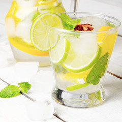 Jug with Lime and Orange Fruit Water with ice