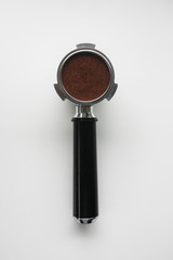 Espresso basket full of coffee grounds from above