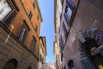 Fototapeta na wymiar Small tiny street between old buildings in Rome. Front door of P