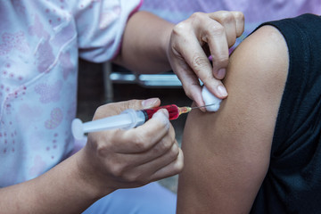 soft focus,nurses are vaccinations to patients using the syringe.Doctor vaccinating women in hospital.Are treated by the use of sterile injectable upper arm.