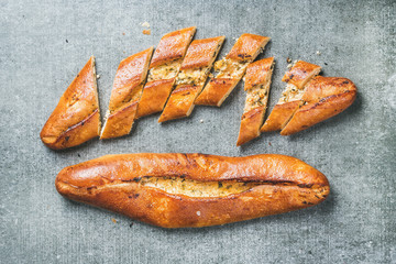 Turkish oriental pizza pide with cheese and spinach over grey stone background, top view, horizontal composition