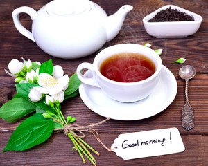 hot black tea in a white cup with a saucer