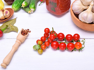 Fototapeta na wymiar cherry tomatoes and spoon with spices