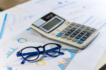 Close up business concept, Calculator and glasses on summary report on table office