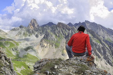 homme assis sur rocher en montagne 