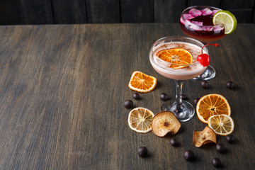 Colorful cocktails over rustic wood background