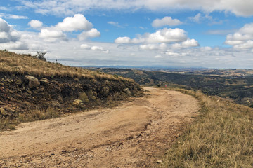 Curved Dirt Road Through Dry Grass Against Winter Landscape