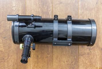 black Newtonian reflector telescope side view