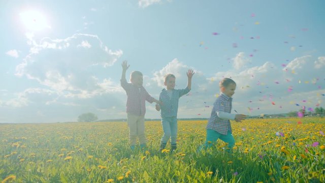 Three little boys exploding party cracker and catching confetti