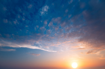 A beautiful sunset with a large sun, shot in the evening in windless weather.