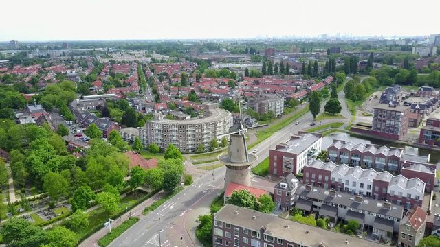 Drone shot of typical Dutch village near Amsterdam, windmill and typical architecture