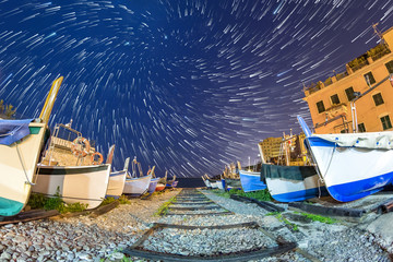 Boat storage at night..Seascape of Genoa Quinto, boats in the foregroung andstar trail in the background.