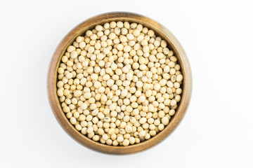 Soybeans in wooden bowl isolated on white background ,top view