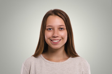 Beautiful  female looking at camera. Smiling girl. Attractive young girl portrait.  Healthy woman studio portrait.