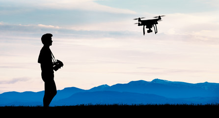 young operating of flying drone quadrocopter and camera