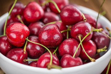 Cherries on wooden background; selective focus