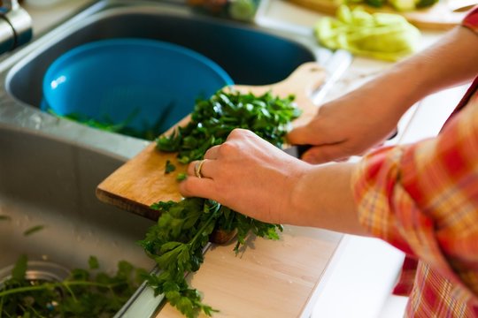 Woman hands chopping green leaves