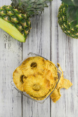 Wooden table with Dried Pineapple Rings, selective focus