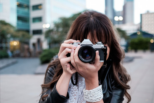 Woman traveling and exploring in the city with a camera