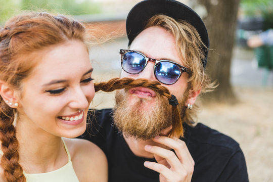 Young Alternative Couple Joking Around with Braids
