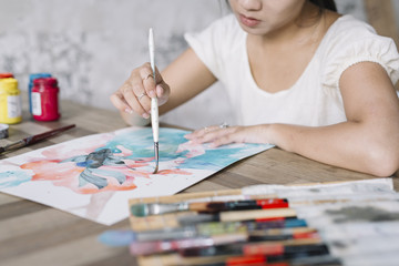 Portrait of Vietnamese woman painting with gouache