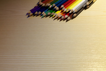 A set of colored pencils over a table. Tips only, room for copyspace. Concept: back to school.
