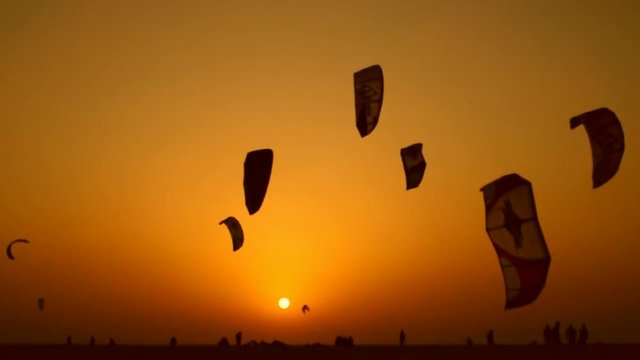 Parachuters at sunset