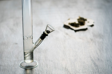 Bong and marijuana, cannabis thc flower Sativa and Indica Close up on a black background. lifestyle Concepts the legalization of marijuana in the world and the United States. Shallow focus effect. © TaylerDerden