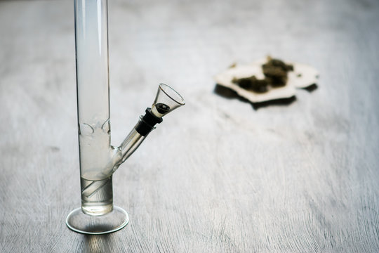 Bong and marijuana, cannabis thc flower Sativa and Indica Close up on a black background. lifestyle Concepts the legalization of marijuana in the world and the United States. Shallow focus effect.