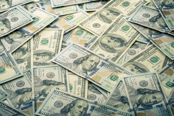Lot of one hundred dollar bills close-up background