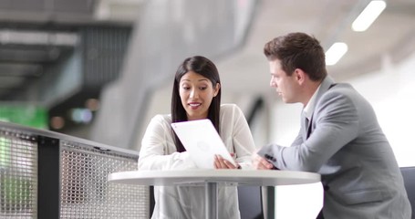 Colleagues in an informal business meeting using a digital tablet