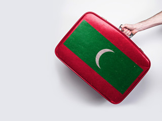 Maldives flag on a vintage leather suitcase.