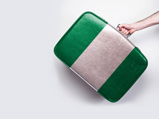 Nigeria flag on a vintage leather suitcase.