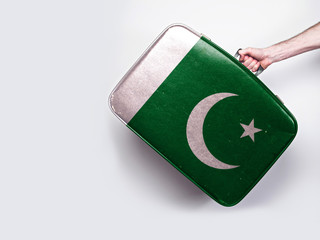 Pakistan flag on a vintage leather suitcase.
