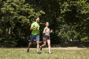 Fototapeta premium Young couple running in nature