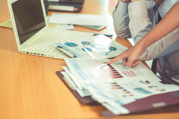 Group of business people analysis with marketing report graph, Young specialists are discussing business ideas for new digital start up project, Financial, accounting, investment, Selective focus.
