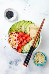 Hawaiian watermelon poke bowl with avocado, cucumber, mung bean sprouts and pickled ginger. Top view, overhead, flat lay