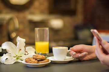 Mulher tomando café da manhã, mesa com alimentos e bebidas